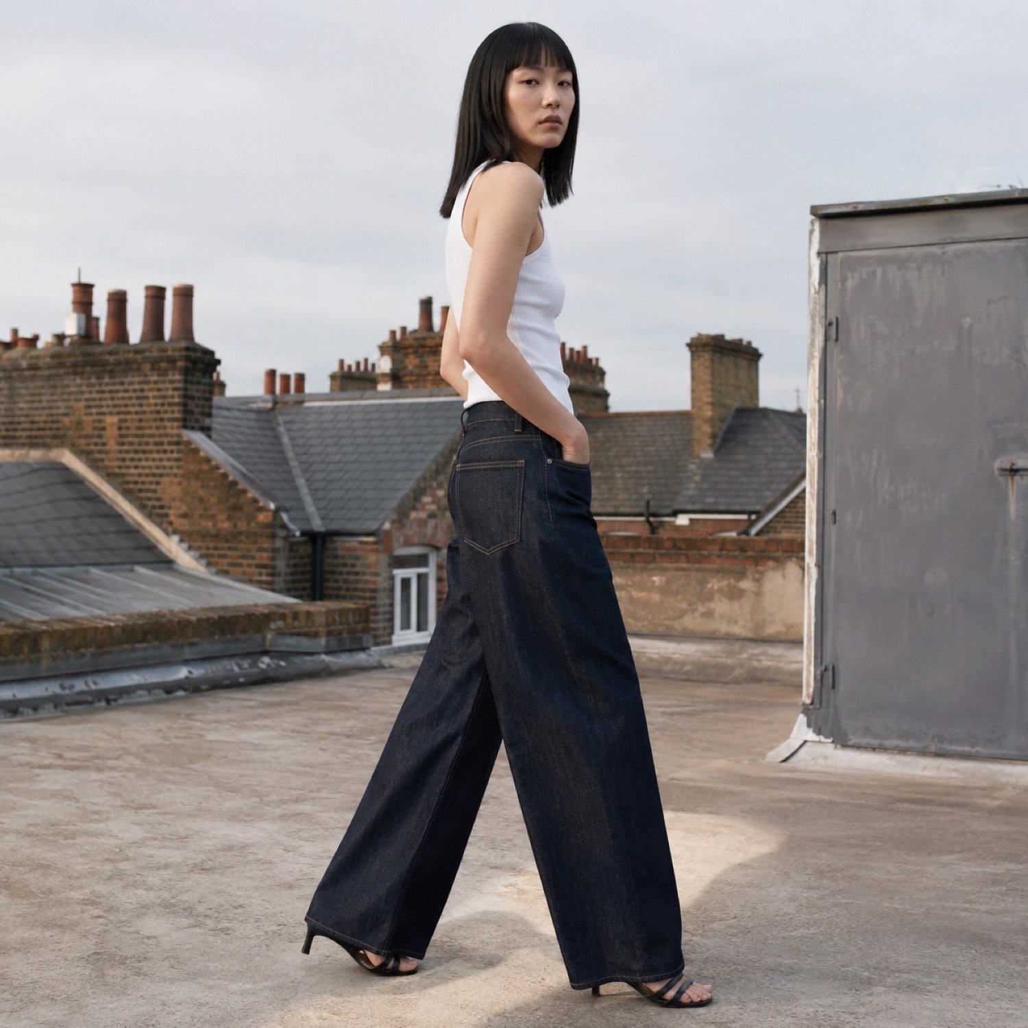 Golden Wide Leg Jean — Jeans by YOON SYM. worn by a model, side view.