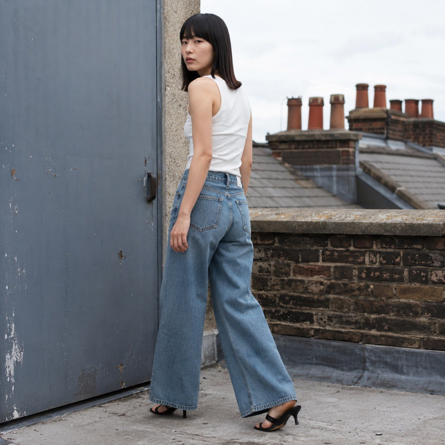 Noel Wide Leg Jean — Jeans by YOON SYM. worn by a model, side view.
