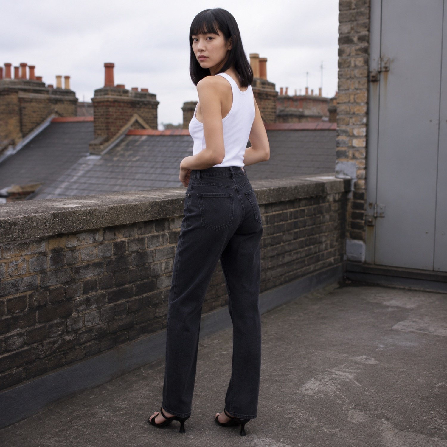 Bridle High Rise Straight Jean — Jeans by YOON SYM. worn by a model, side view.