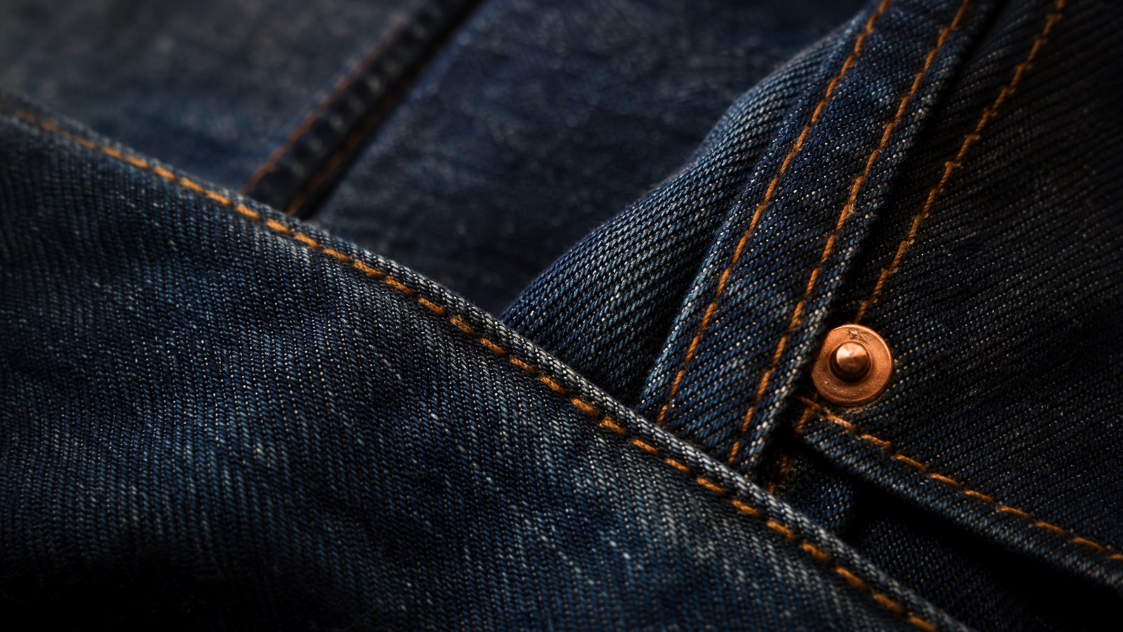 Close detail of overlapping charcoal ribbed and oatmeal cable knitted fabric