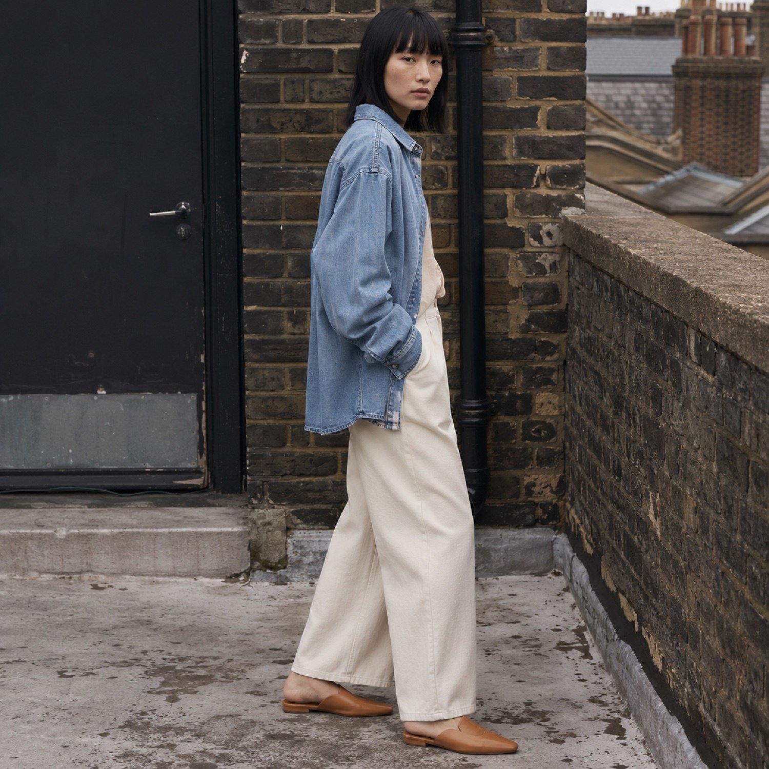 Soho Oversized Denim Shirt — Denim Shirts by YOON SYM. worn by a model, side view.