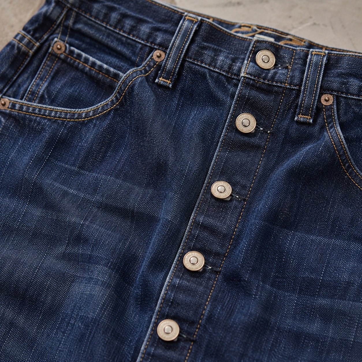 YOON SYM: Kingly Button Front Denim Skirt, Skirts & Dresses, detail of the surface and seams.
